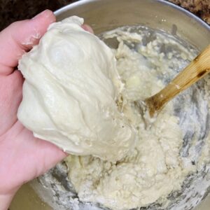 Sweet stiff starter being incorporated into bread dough
